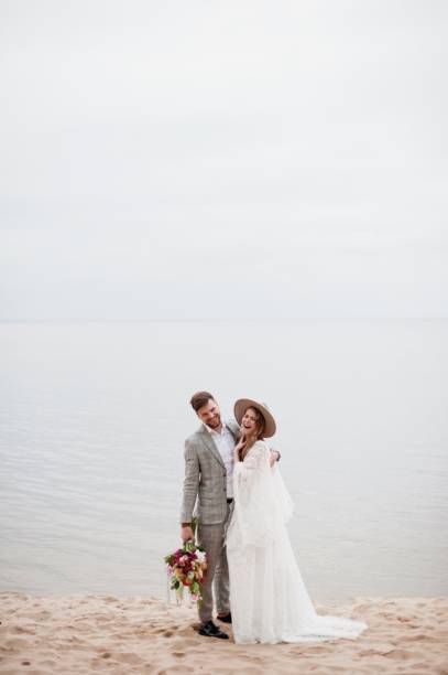 istock Bride And Bridegroom Standing At Beach During Wedding Ceremony 1049862998