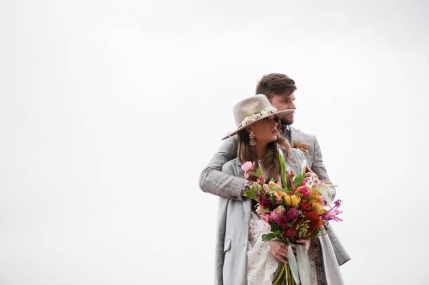istock Bride And Bridegroom Standing Against Clear Sky 1049863018