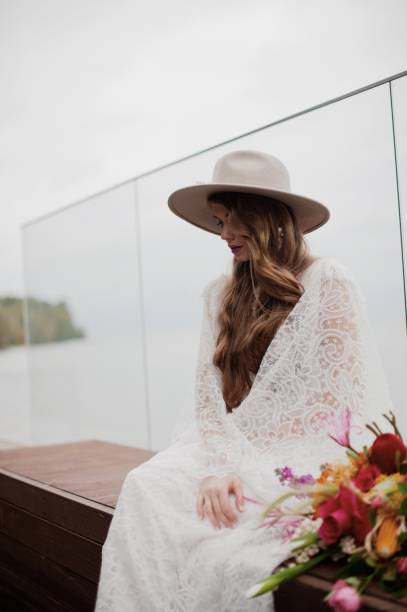 istock Bride Sitting Against Glass Railing 1049863066