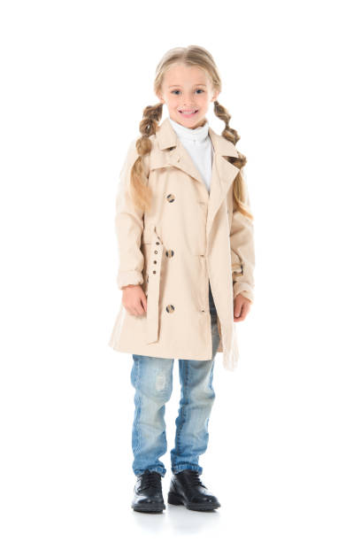 istock adorable kid posing in beige coat, isolated on white 1049863206