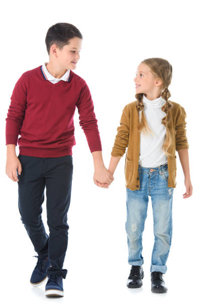 istock brother and sister holding hands isolated on white 1049869950