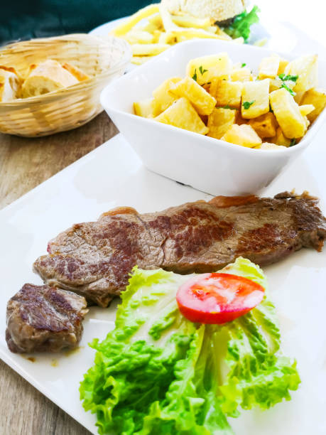 istock juicy steak beef meat with tomato and potatoes 1049870312
