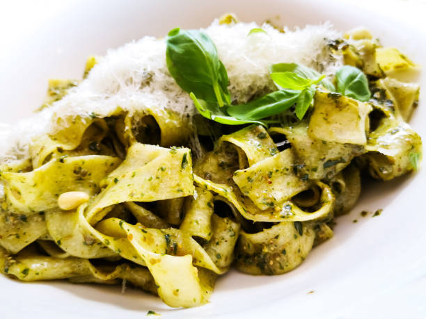 istock Pasta with pesto sauce and nuts on a the table 1049870510