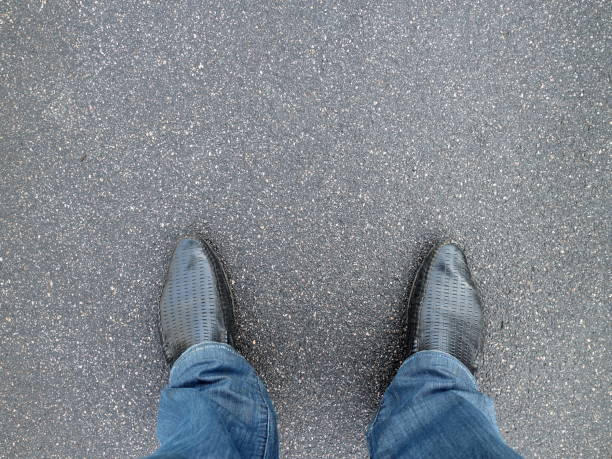 istock Blue pants and shoes on asphalt 1049876880