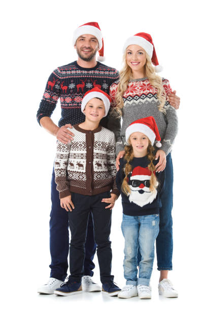 happy family with kids posing in christmas sweaters and santa hats, isolated on white happy family with kids posing in christmas sweaters and santa hats, isolated on white christmas sweater photos stock pictures, royalty-free photos & images