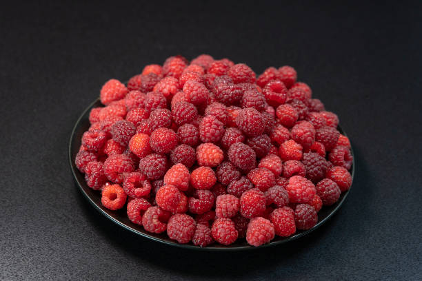 istock Fresh, ripe, juicy red raspberry background, close up berry, macro 1049876982