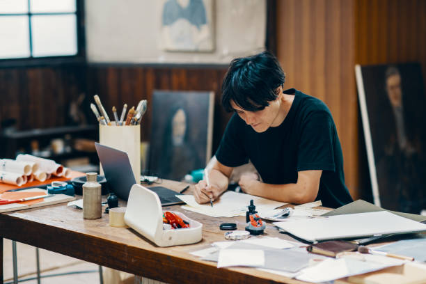 istock Mature male artist sketching ideas in his studio 1049885010