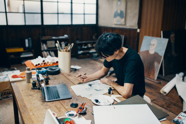 istock Mature male artist sketching ideas in his studio 1049885012