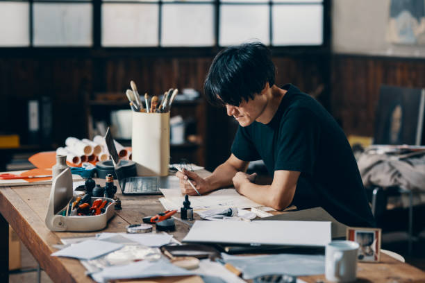istock Mature male artist sketching ideas in his studio 1049885118