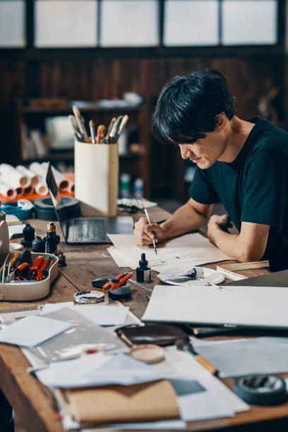 istock Mature male artist sketching ideas in his studio 1049885122
