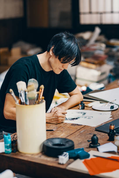 istock Mature male artist sketching ideas in his studio 1049885130