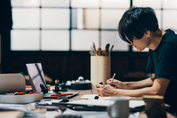 istock Mature male artist sketching ideas in his studio 1049885136