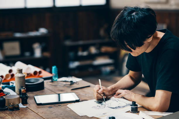 istock Mature male artist sketching ideas in his studio 1049885148