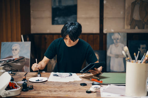 istock Mature male artist sketching ideas in his studio 1049885162