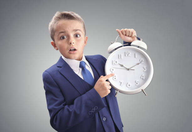 Time on clock shocked and surprised late young executive businessman boy concept for appointment, meeting, urgency and running late