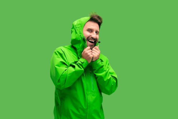 istock handsome bearded young man looking at camera isolated on green 1049888232