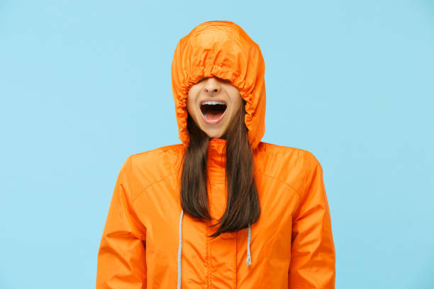 istock The young surprised couplel posing at studio in autumn jackets isolated on blue 1049888420
