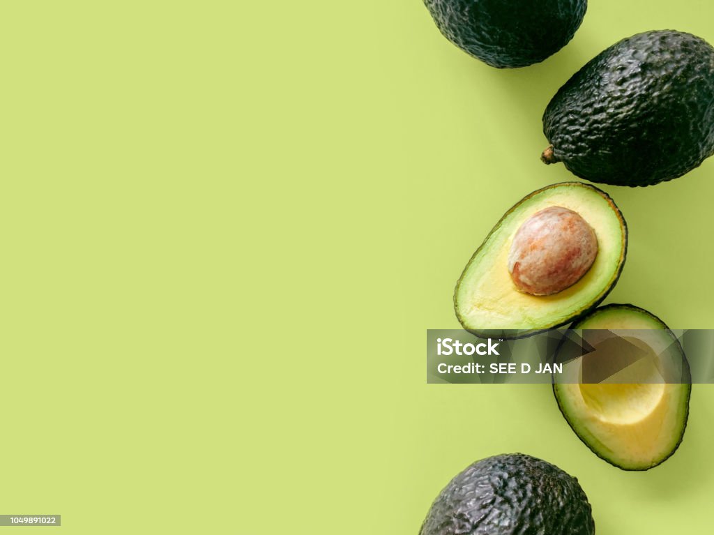 Hass avocado Fresh organic hass avocados on a green background, top view with copy space Avocado Stock Photo