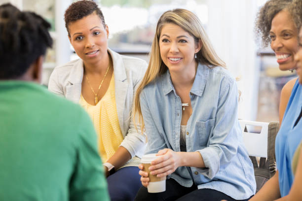 istock Attentive woman during group counseling session 1049891274