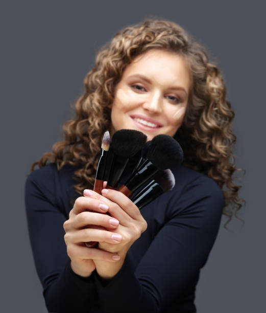 istock Applying Make-up. Woman with a brush for make-up 1049894566
