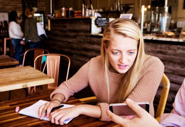 istock Leaning over to check social media update from a friend 1049897962