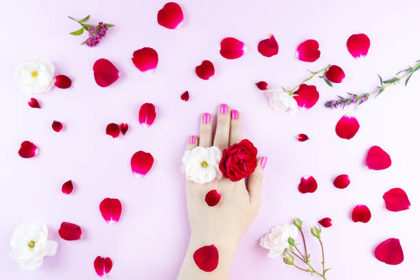 istock beauty hands with makeup and flowers 1049898508