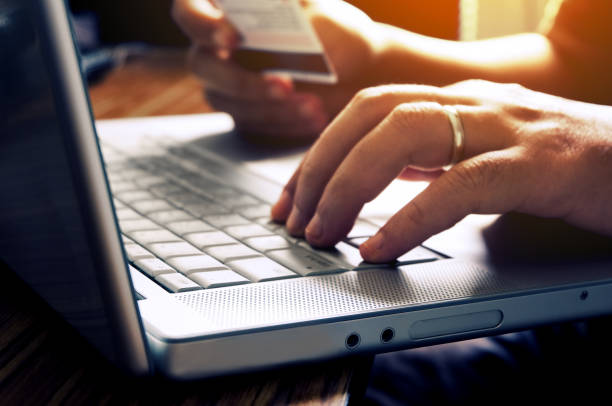 istock Man's hands using credit card for online shopping. 1049898576