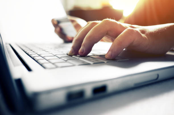 istock Man's hands using credit card for online shopping. 1049898622