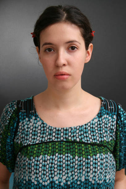 Portrait of young woman looking at camera wearing folk casual clothes.