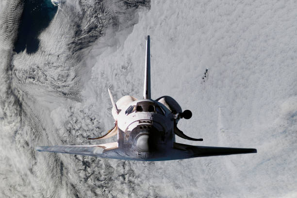 istock space ship shuttle flying near earth from the hurricane and massive clouds in atmosphere, image made of NASA photos f 1049900978