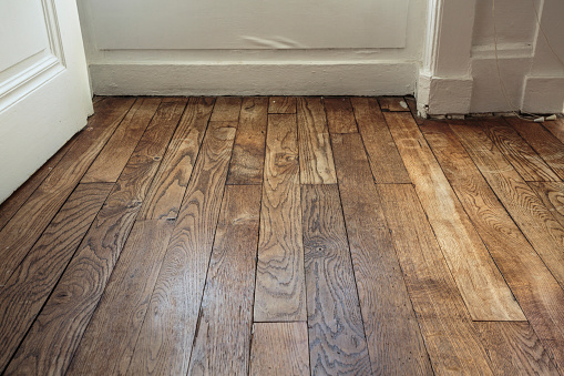 Floor made from wooden planks in very old french apartment