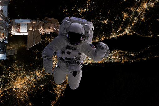 astronaut flying in open space over the USA during night, near earth. Image made of NASA photos