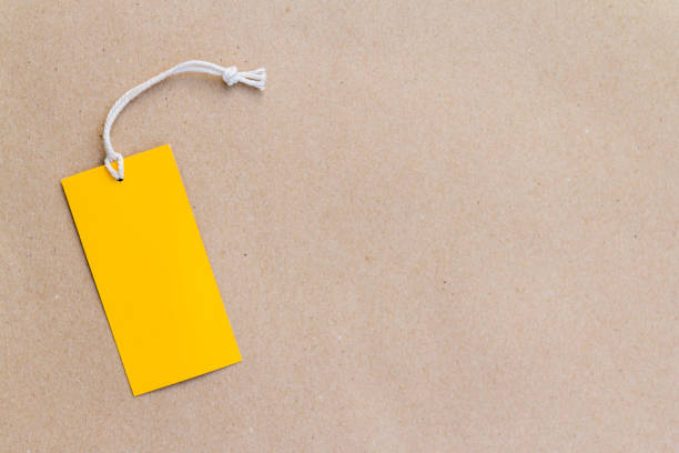 istock Emtry yellow price tag on brown paper background 1049901264