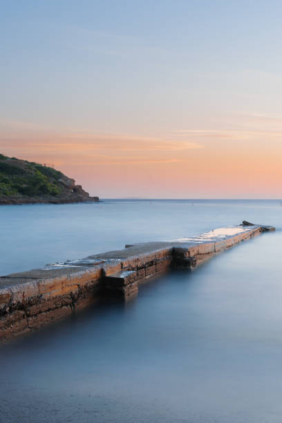 istock Stone pier, water long exposure 1049904222