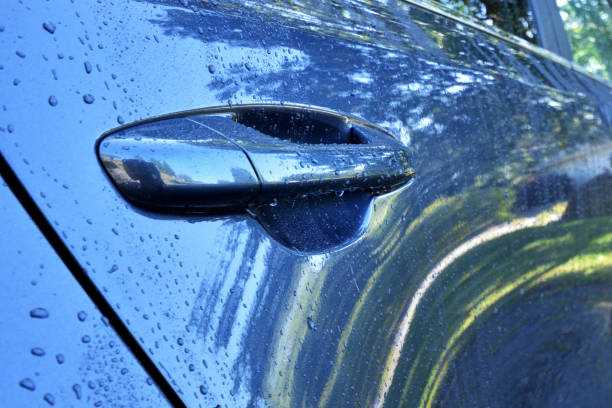 istock Rain Drops on a Vehicle Door Abstract 1049907620