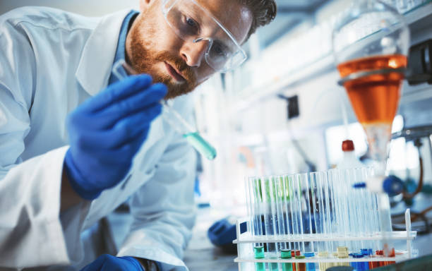 Male student of chemistry working in laboratory Male attractive student of chemistry working in laboratory test tube stock pictures, royalty-free photos & images