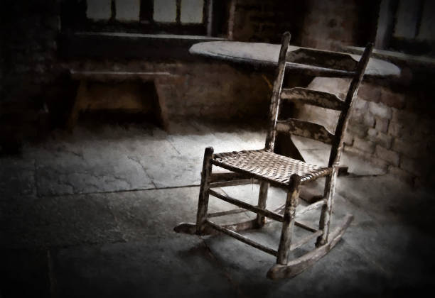Old Rocking Chair in Black and White. The seat of the chair is a basket weave.