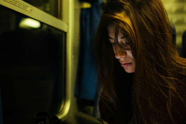 istock A girl watching at her phone on the train 1049914156