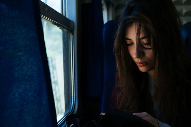 istock A girl watching at her phone on the train 1049914174