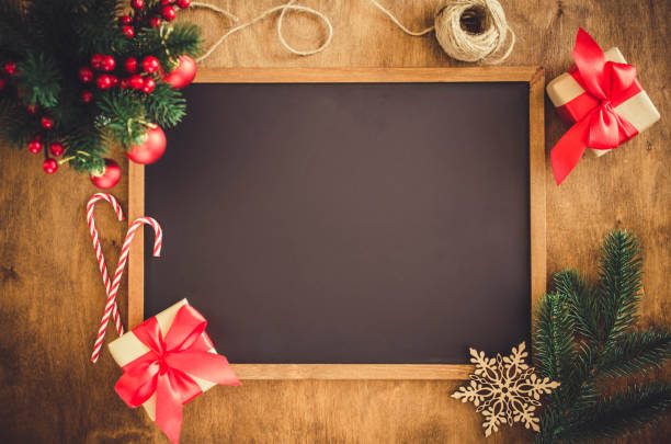 istock Empty blackboard with christmas decoration, red gift box, fir branches. 1049916600