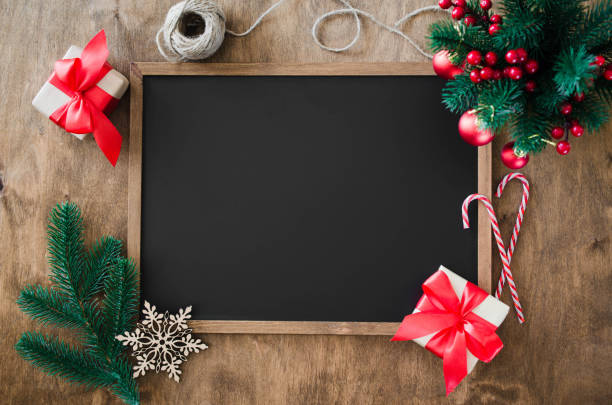 istock Empty blackboard with christmas decoration, red gift box, fir branches. 1049916608