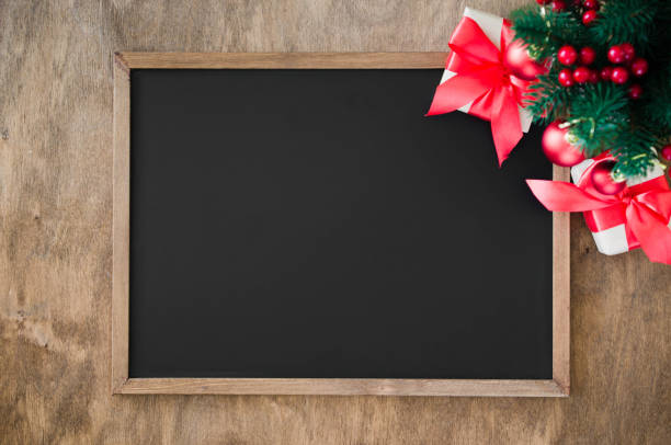 istock Empty blackboard with christmas decoration, red gift box, fir branches. 1049916636