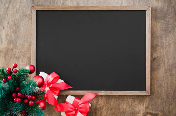istock Empty blackboard with christmas decoration, red gift box, fir branches. 1049916642