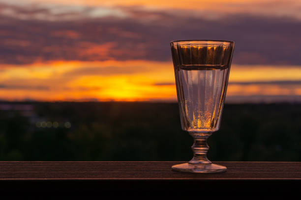 istock A glass of vodka on a sunset background 1049919426