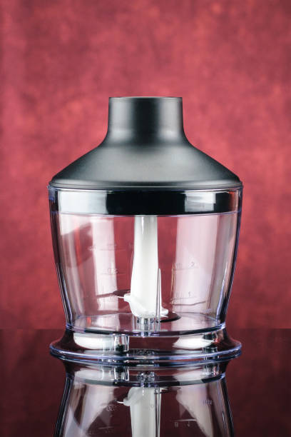 istock Transparent glass chopper for blender on the red mirror background 1049919904