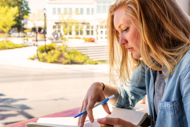 istock Sitting by the window of a cafe reading a book 1049926522
