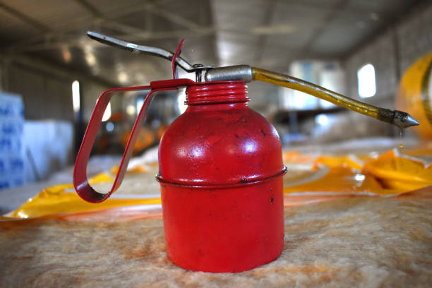 istock old red bucket for oil. 1049929124
