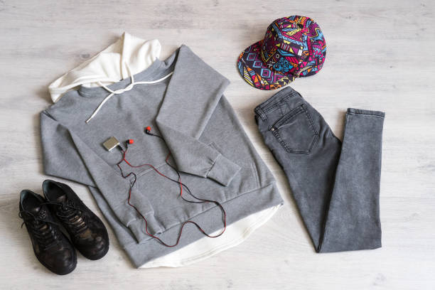 istock Teen clothing set: grey sweatshirt, black jeans, boots in military style and colored cap 1049932622