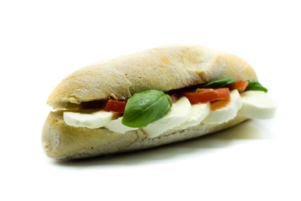 istock Mozzarella tomato baguette with basil isolated on white background 1049938234