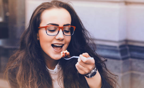 istock Beautiful woman eating cake 1049941712